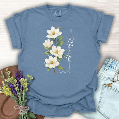 Blue Jean S relaxed-fit, garment-dyed cotton t-shirt with a magnolia illustration and Mississippi state outline.