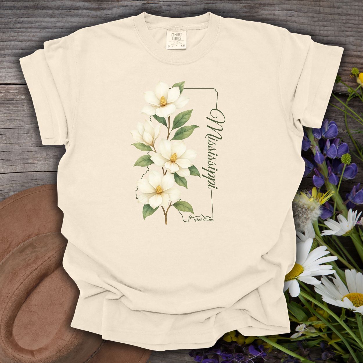 Ivory S, relaxed-fit, garment-dyed cotton t-shirt with a magnolia illustration and Mississippi state outline.