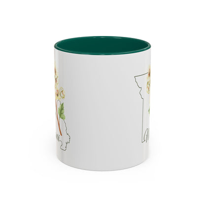 White ceramic mug with green interior and handle, featuring a watercolor hawthorn flower over a Missouri outline.