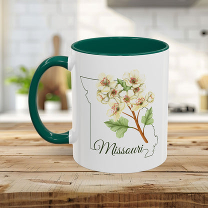 White ceramic mug with a green interior and handle, featuring a watercolor hawthorn flower over a Missouri outline.