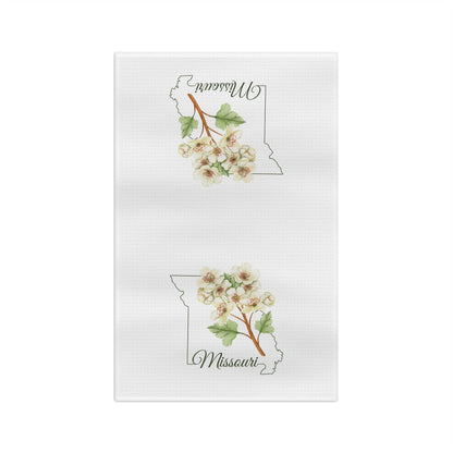 White microfiber tea towel with a Missouri outline and cream-and-pink hawthorn blooms.