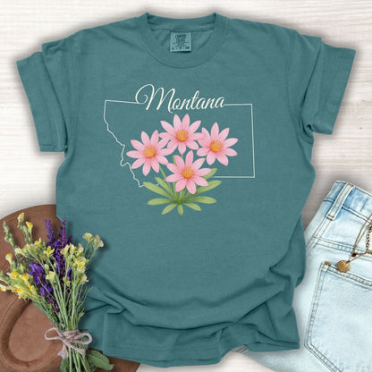 Blue Spruce Montana State Flower T-Shirt with pink Bitterroot wildflowers and a white outline of Montana.