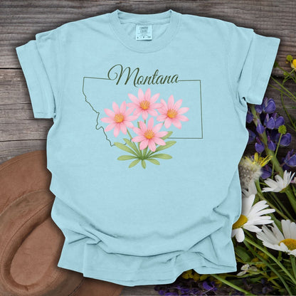 Chambray blue cotton t-shirt with a Montana outline and pink bitterroot wildflowers.