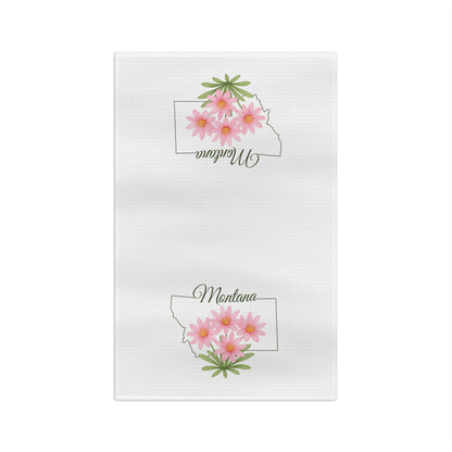 White microfiber tea towel with Montana outline and pink bitterroot flowers.