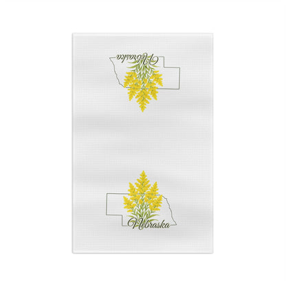 White microfiber tea towel with goldenrod inside a Nebraska state outline and "Nebraska" script.