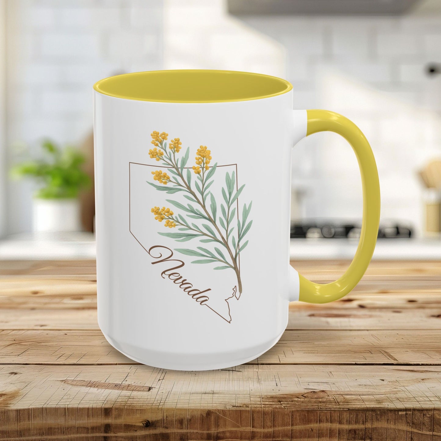 15oz ceramic mug with yellow interior/handle, featuring a Nevada state outline and sagebrush botanical print.
