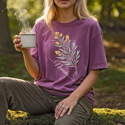 Relaxed-fit, garment-dyed plum t-shirt with Nevada state outline and sagebrush floral design.