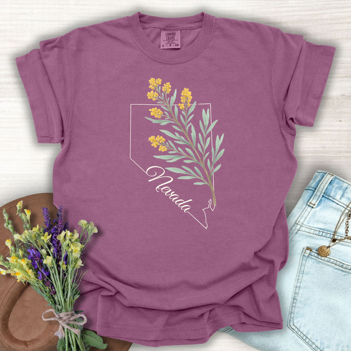 Berry S t-shirt with Nevada state outline and hand-drawn sagebrush floral design.