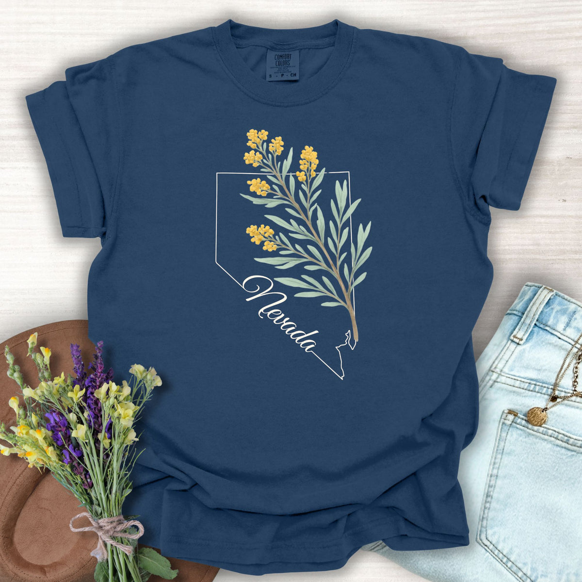 True Navy S t-shirt with a white Nevada state outline and yellow sagebrush floral design.