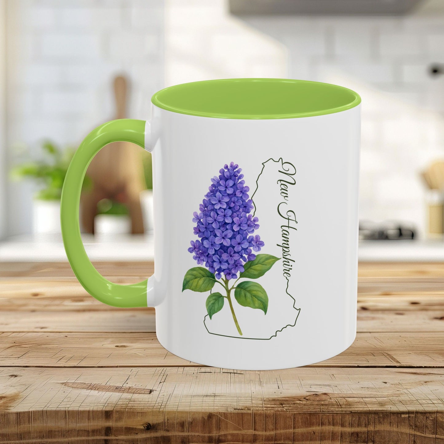 White ceramic mug with green handle and interior, featuring a vibrant purple lilac and New Hampshire outline.