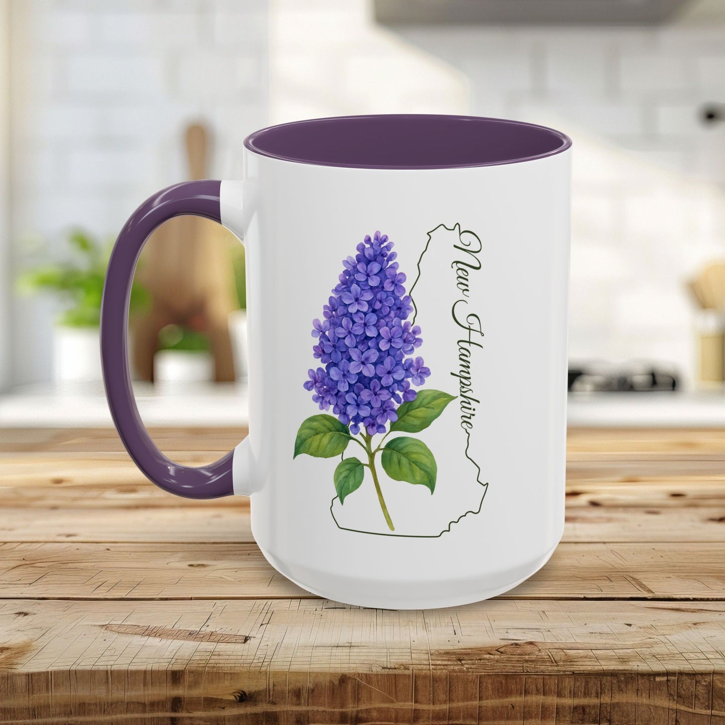 White ceramic mug with purple lilac flower, New Hampshire outline, and purple handle/interior.