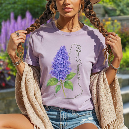 Woman in a relaxed-fit, lavender garment-dyed t-shirt with a watercolor lilac and New Hampshire outline.