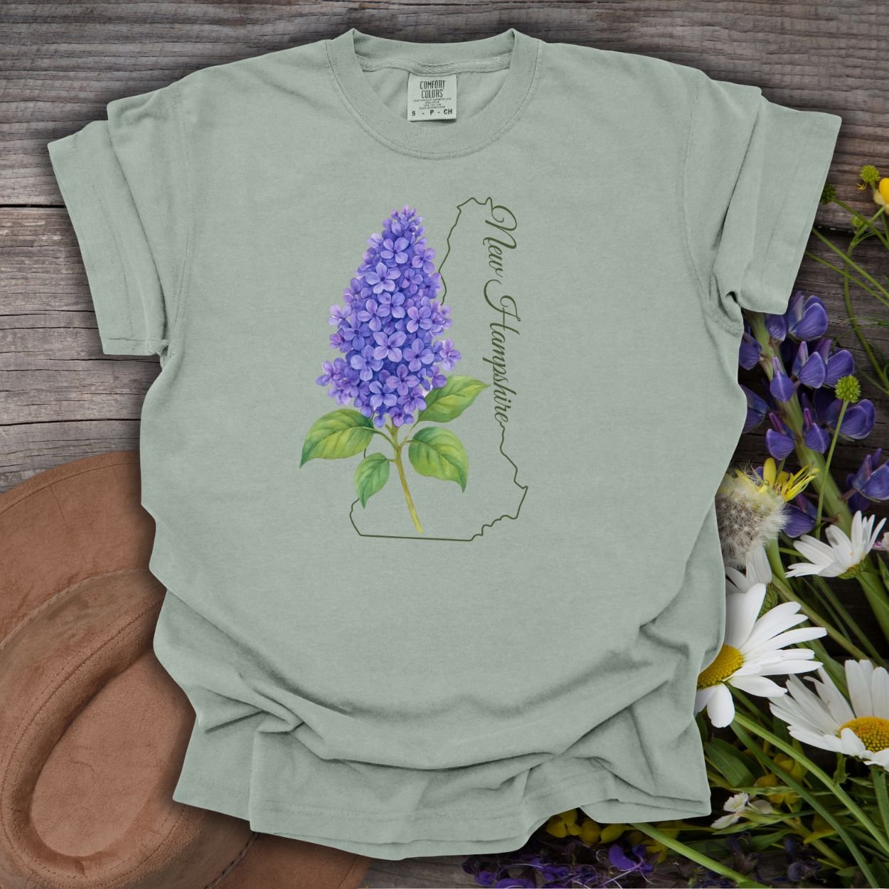 Bay-colored, relaxed-fit cotton t-shirt with a watercolor lilac sprig and New Hampshire outline.