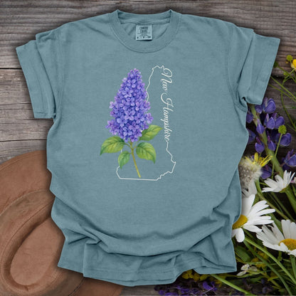 Ice Blue S t-shirt with a watercolor lilac sprig and New Hampshire state outline.