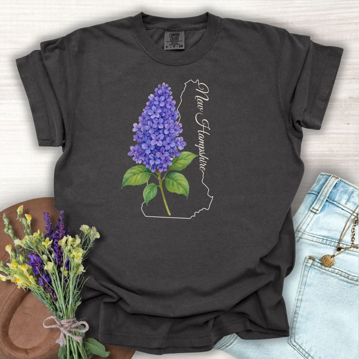 Pepper S t-shirt with watercolor blue lilac, New Hampshire outline, and script.
