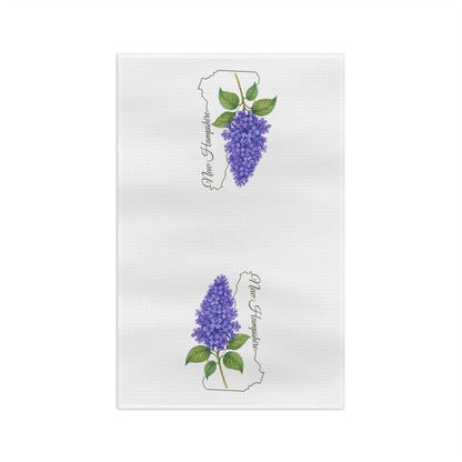 Microfiber tea towel with two purple lilac sprigs over a New Hampshire state outline and handwritten name.