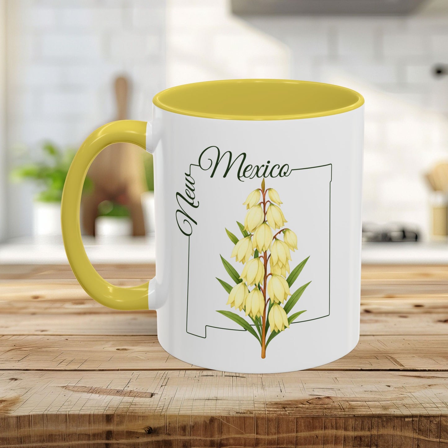 White ceramic mug with yellow interior and handle, featuring a Yucca flower and New Mexico outline.