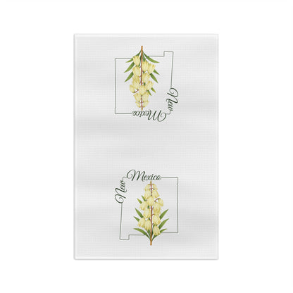 White microfiber tea towel with watercolor yucca blooms and "New Mexico" over a state outline.
