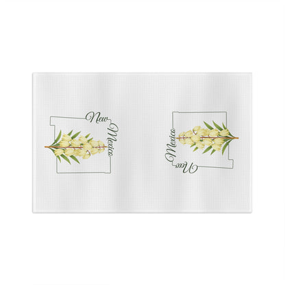 White microfiber tea towel with two New Mexico state outlines and watercolor yucca blooms.