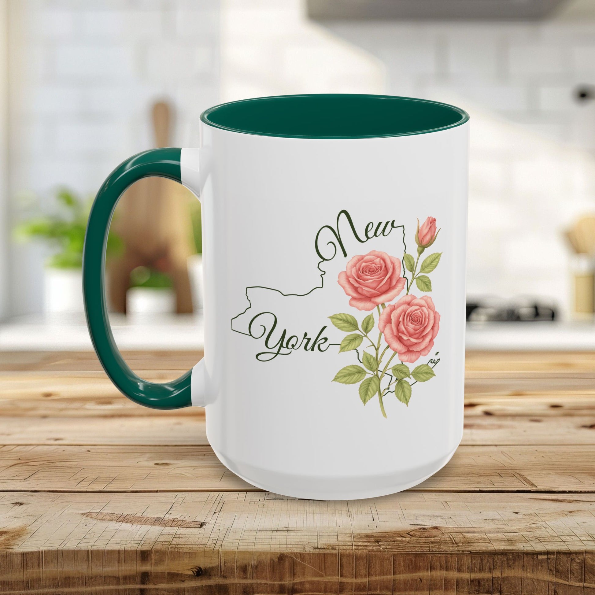 White ceramic mug with green handle and interior, featuring New York outline, script, and pink roses.