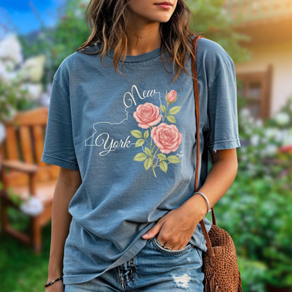 Garment-dyed blue cotton t-shirt with a New York state outline, "New York" text, and painterly pink roses.
