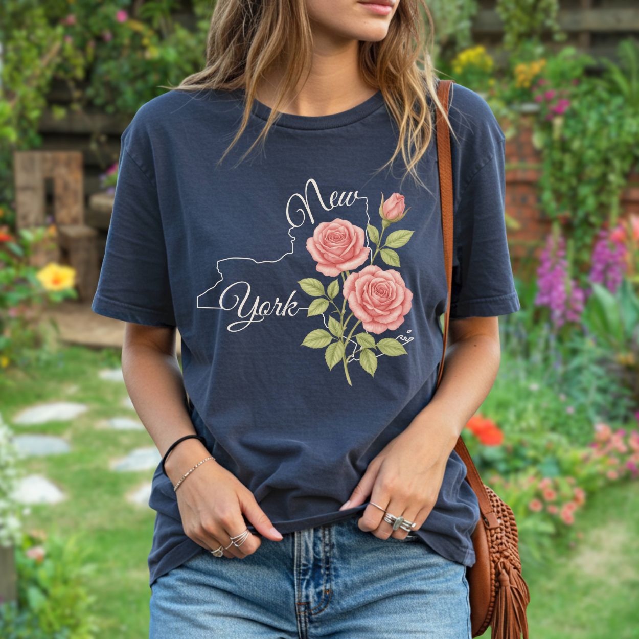 Garment-dyed navy cotton t-shirt with a New York state outline and painterly pink roses.