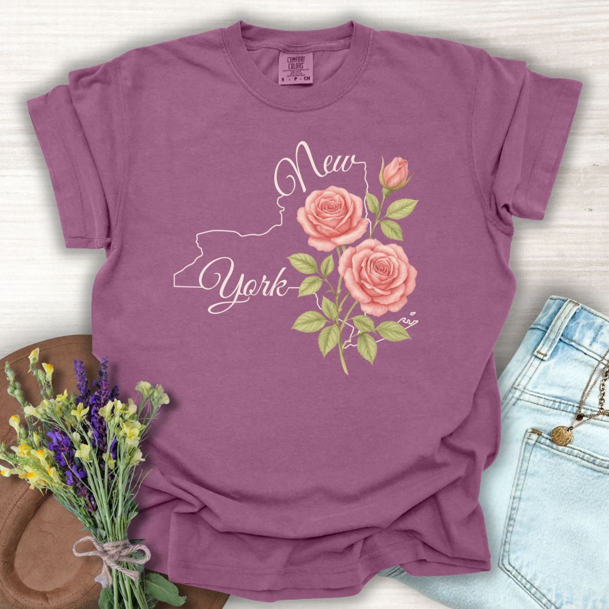 Berry S t-shirt with a New York state outline, hand-lettered text, and painterly pink roses.