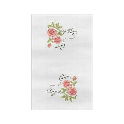 White microfiber tea towel with pink roses and green leaves framing a "New York" state outline.