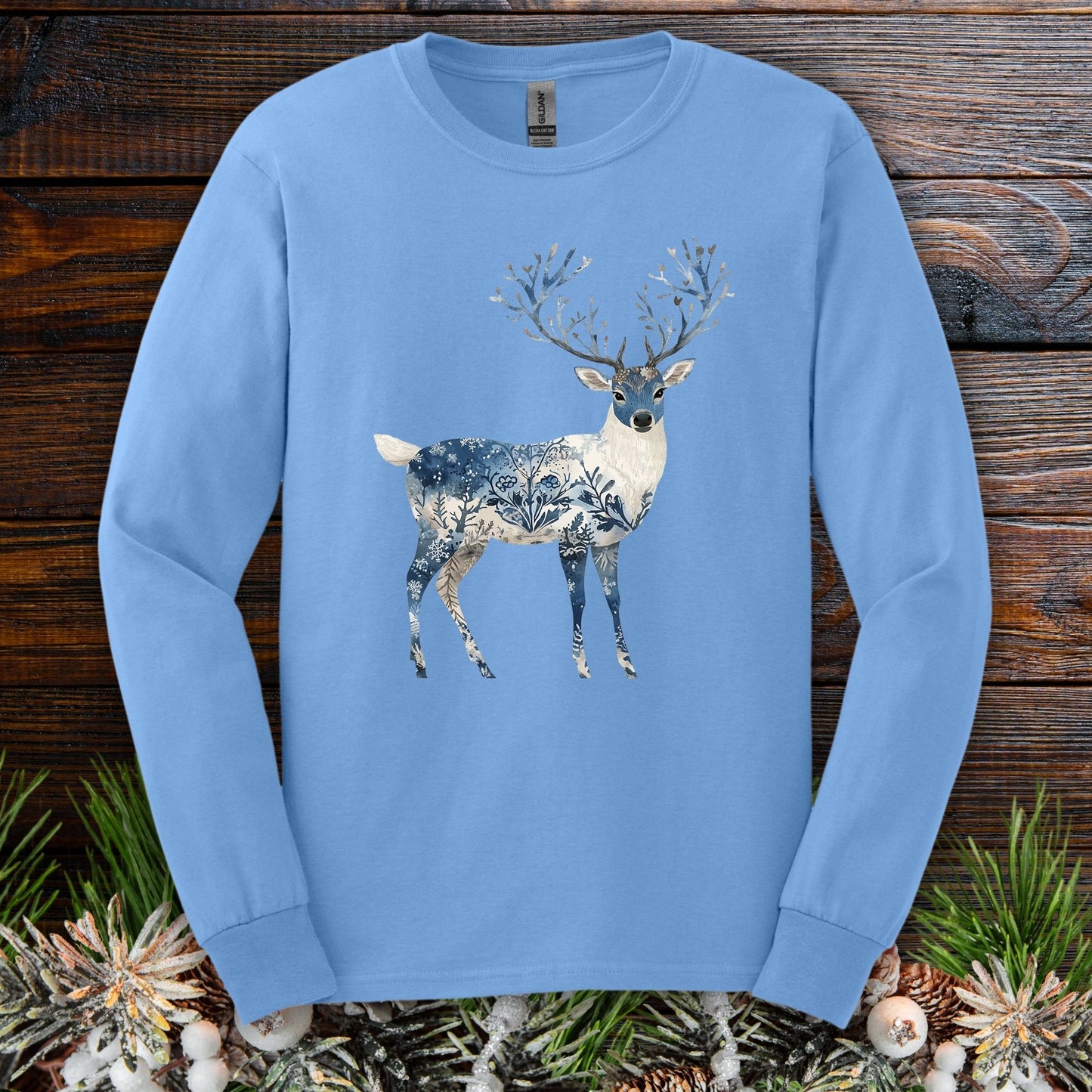 Carolina Blue long sleeve tee with a white stag featuring blue floral and winter landscape patterns.