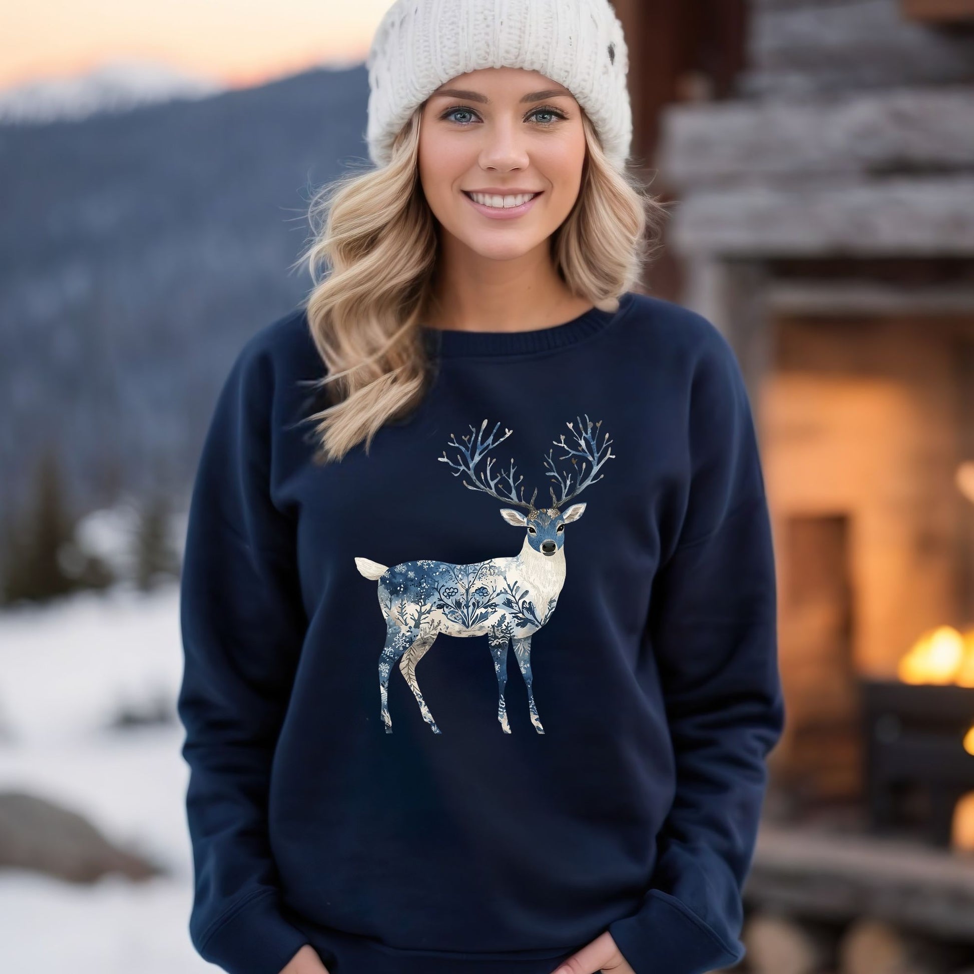Woman in white beanie wearing a navy sweatshirt with a white, blue, and brown botanical deer design.