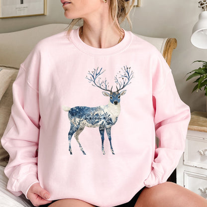 Pink cotton-poly sweatshirt with a stylized deer featuring blue botanical and frost patterns, and tree-like antlers.
