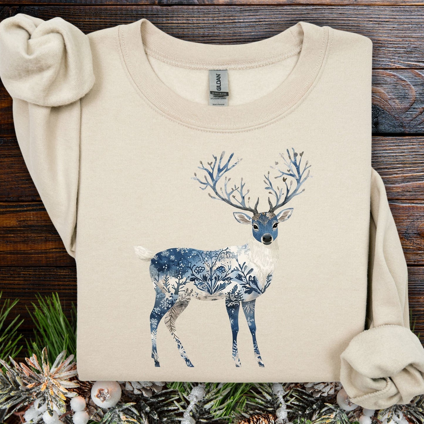 Sand S sweatshirt with a blue and white Nordic Chinoiserie winter buck illustration.