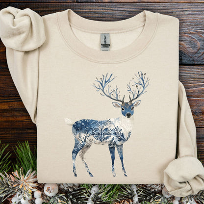Sand S sweatshirt with a blue and white Nordic Chinoiserie winter buck illustration.