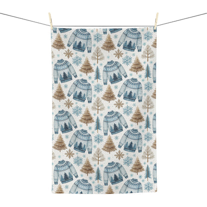 Nordic Fair Isle sweater microfiber tea towel with blue sweaters, pine trees, and snowflakes.