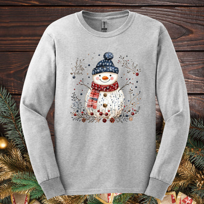 Ash Gildan Softstyle long sleeve tee with a hand-drawn Nordic folk art snowman and winter foliage design.