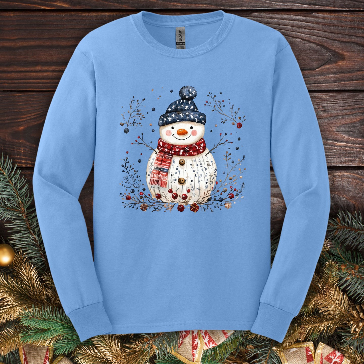 Carolina Blue Gildan Softstyle long sleeve tee with a Nordic folk art snowman design.