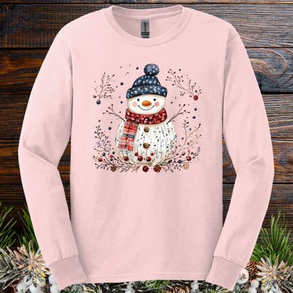 Light pink Gildan Softstyle long sleeve tee with a hand-drawn Nordic folk art snowman design.