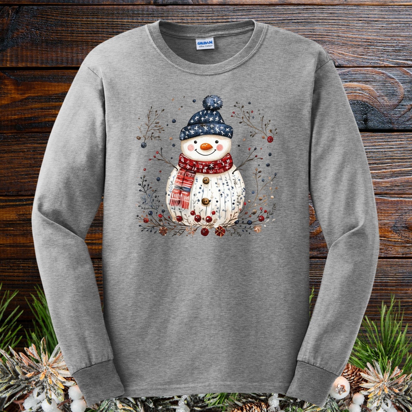 Sport Grey Gildan Softstyle long sleeve tee with a watercolor Nordic folk art snowman design.