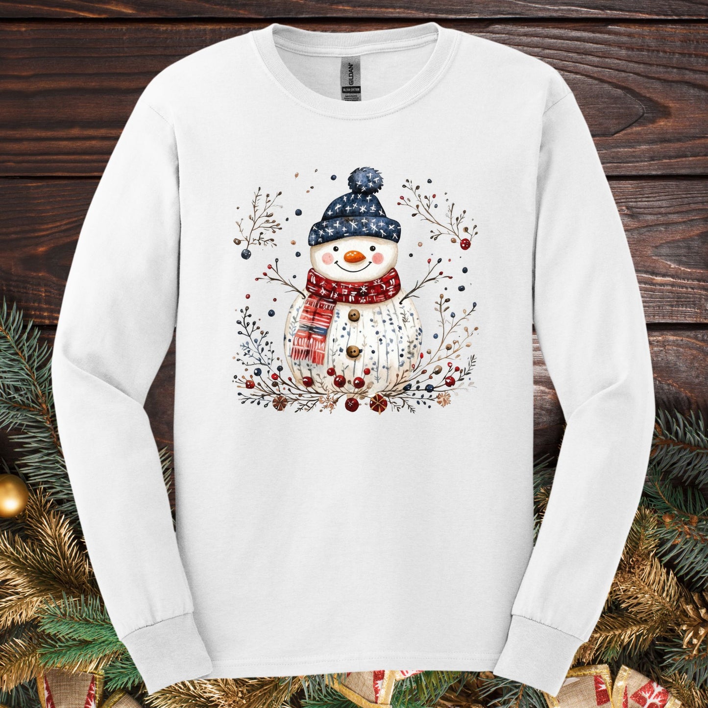 White Gildan Softstyle long sleeve tee with a watercolor Nordic folk art snowman design.