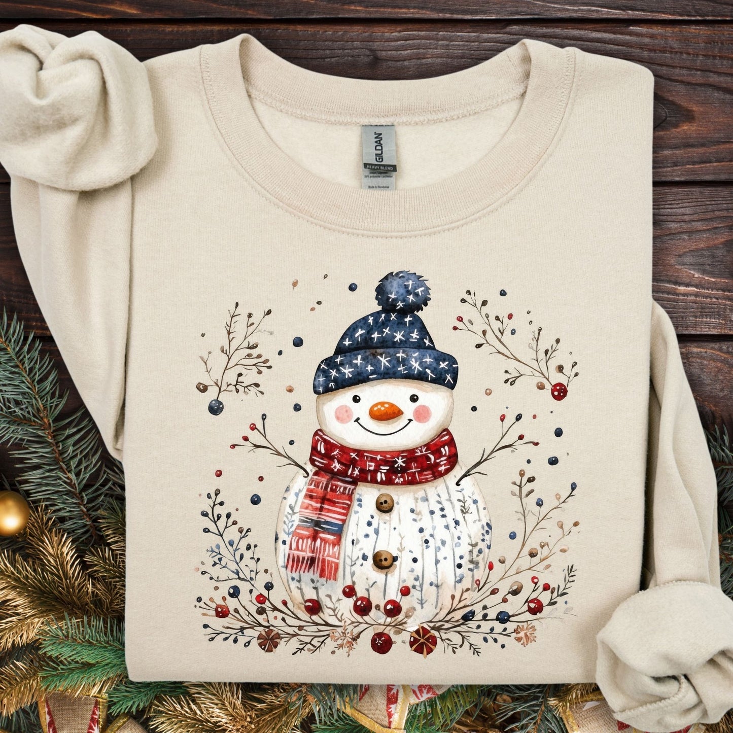 Sand Gildan fleece sweatshirt with a Nordic folk-art snowman, berries, and branches design.