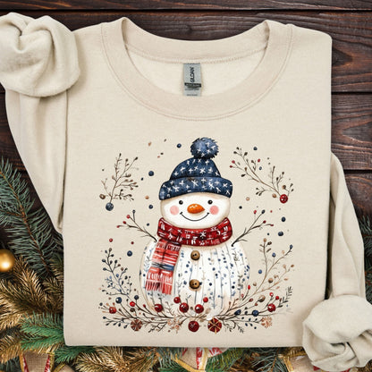 Sand Gildan fleece sweatshirt with a Nordic folk-art snowman, berries, and branches design.