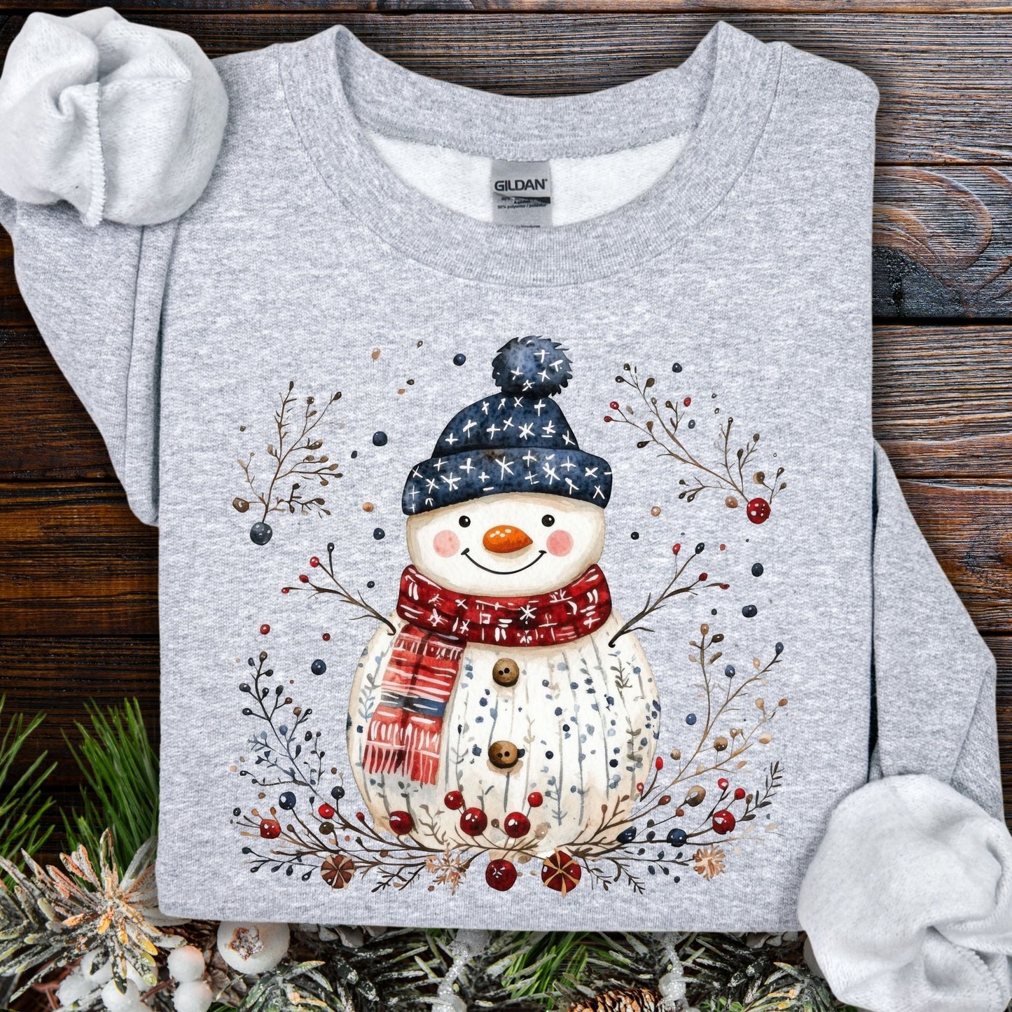 Sport Grey Gildan sweatshirt with a Nordic folk-art snowman, branches, and berries design.
