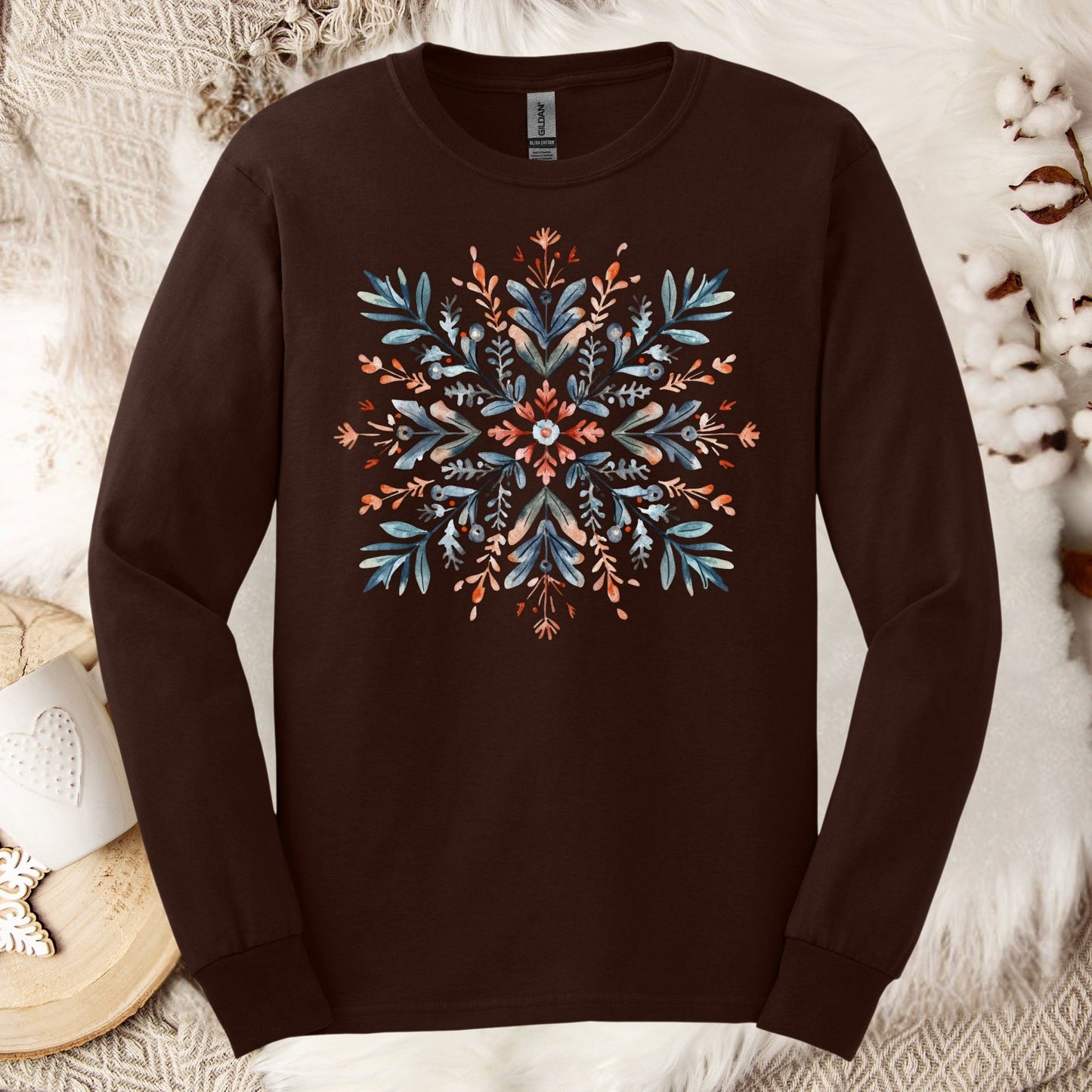 Dark Chocolate Gildan Softstyle long sleeve tee with a watercolor Scandinavian snowflake in red and blue.