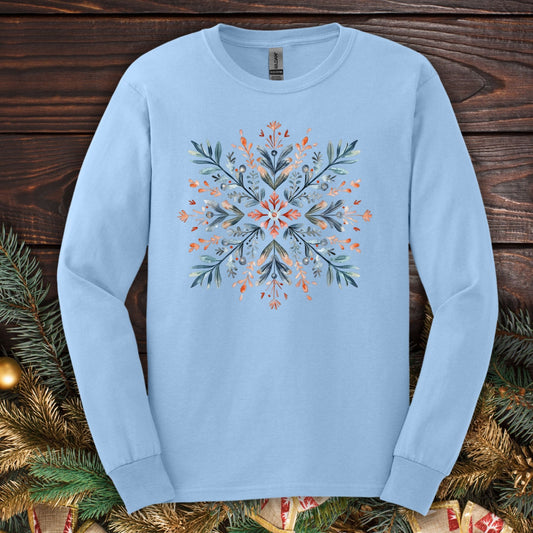 Light blue Gildan long sleeve tee with a watercolor Nordic snowflake design in red, blue, and green.