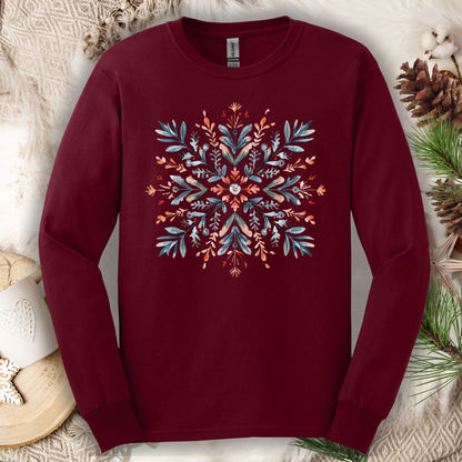 Maroon Gildan Softstyle long sleeve tee with a watercolor Scandinavian snowflake design in red and blue.