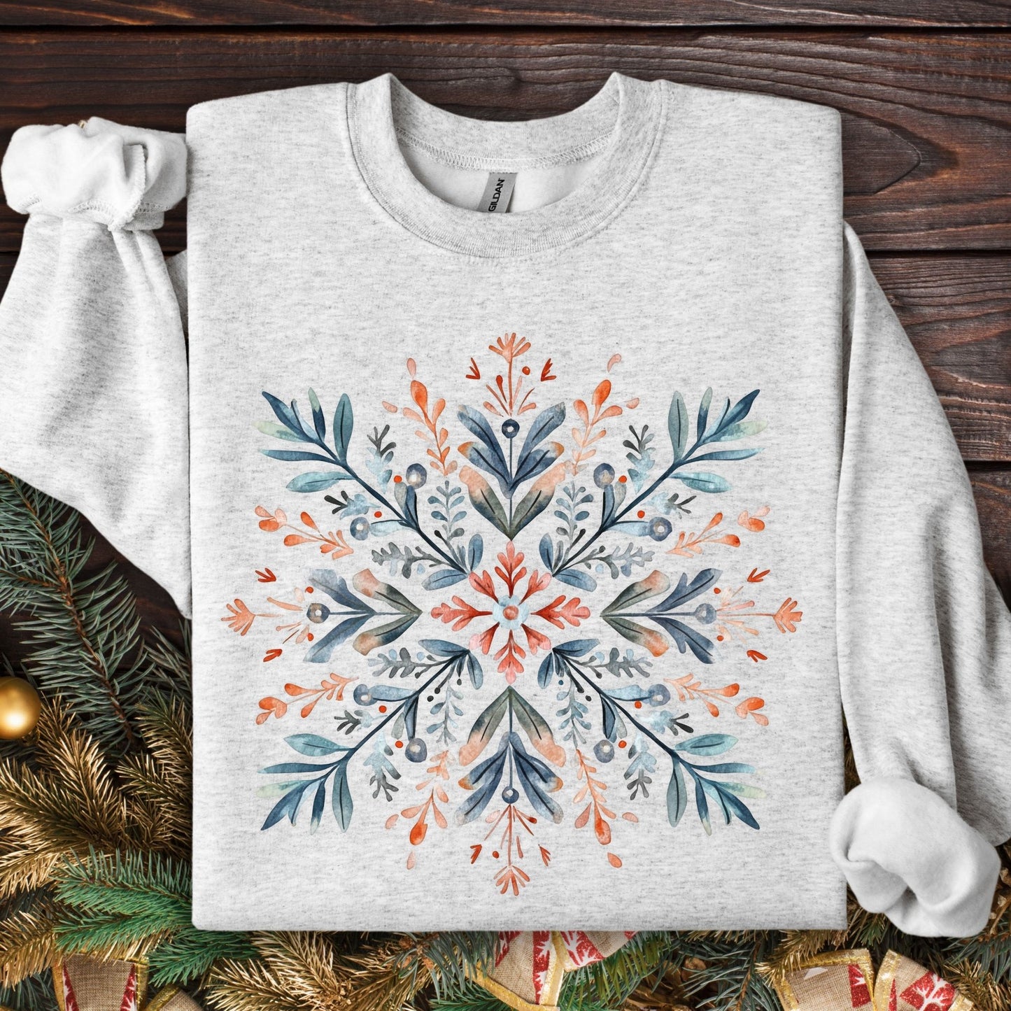 Ash grey Gildan fleece sweatshirt with a large, central Nordic watercolor snowflake in red, blue, and green.