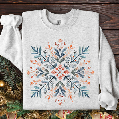 Ash grey Gildan fleece sweatshirt with a large, central Nordic watercolor snowflake in red, blue, and green.