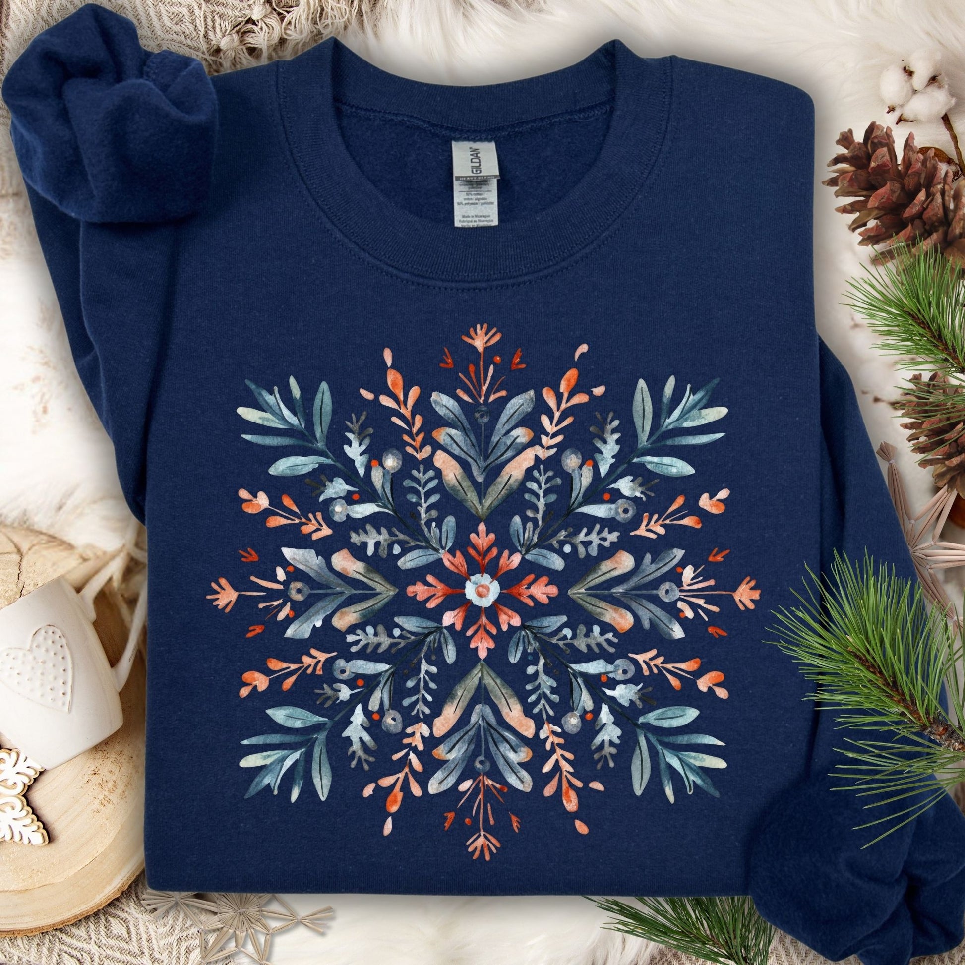 Navy Gildan fleece sweatshirt with a watercolor Nordic snowflake design in red and blue.