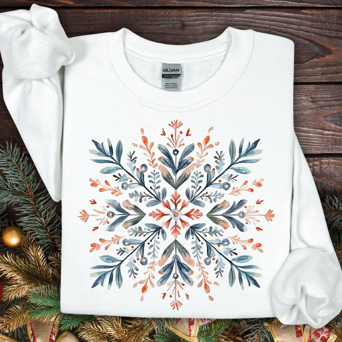White Gildan fleece sweatshirt with a watercolor Nordic snowflake design in red and blue.
