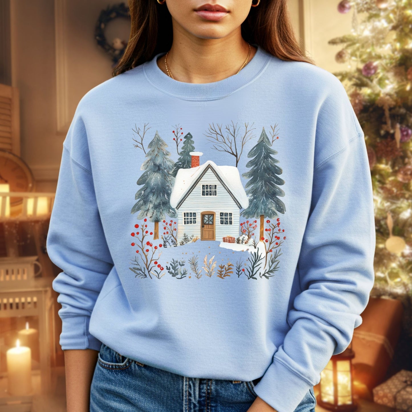 Light blue crewneck sweatshirt with a snowy Nordic cabin, pine trees, and red berries.